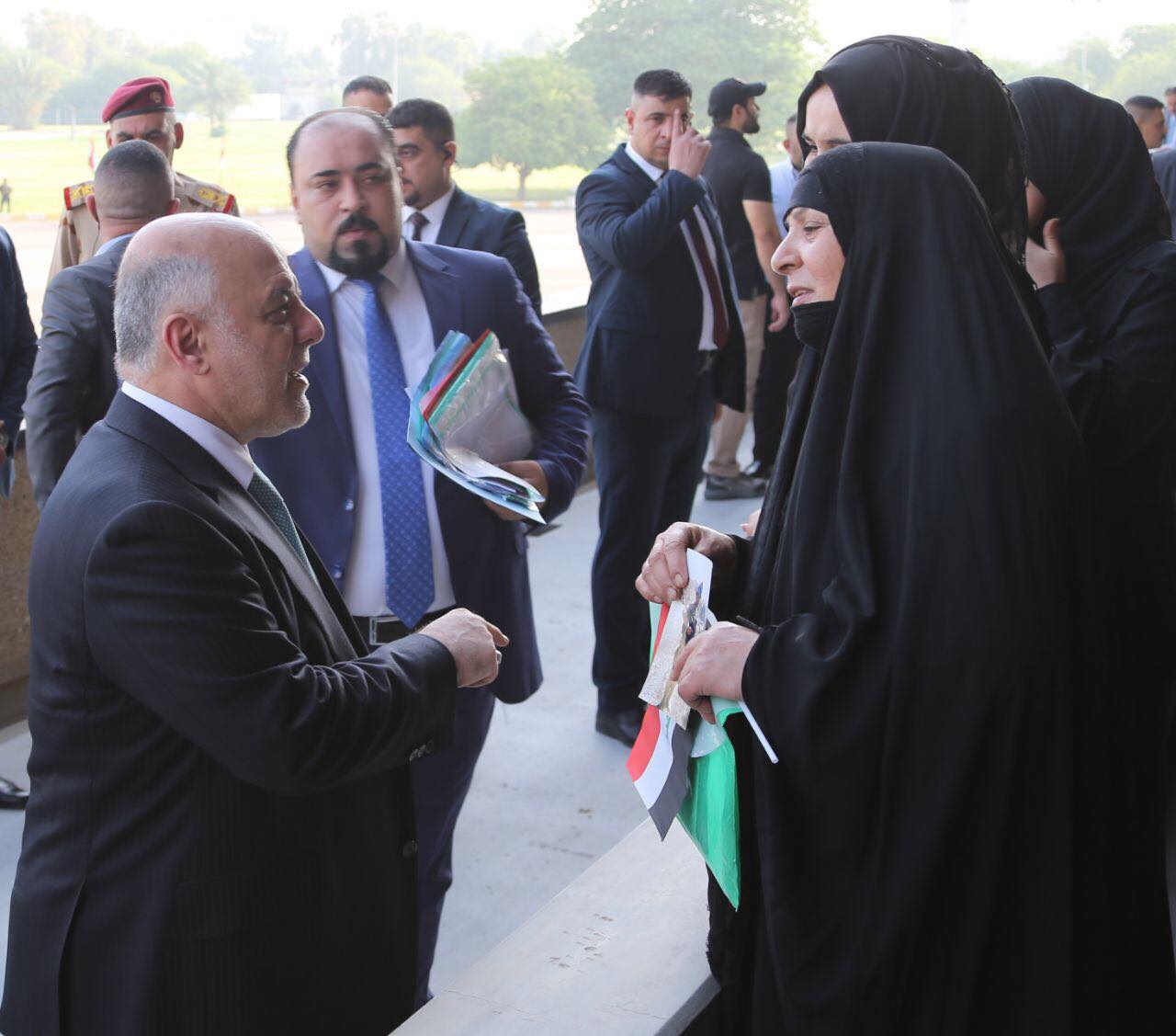 Iraqi Prime Minister Haider al-Abadi with the families of the fallen Iraqi soldiers during the military parade in Baghdad, July 15, 2017. (Photo: Iraqi Prime Minister’s Press Office)